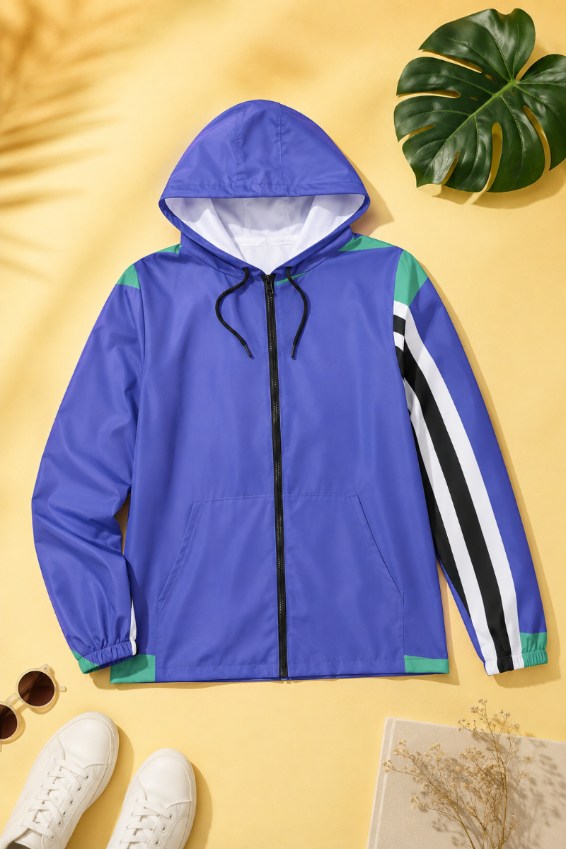 Retro Lines blue color block windbreaker jacket styled in a yellow editorial flat lay.