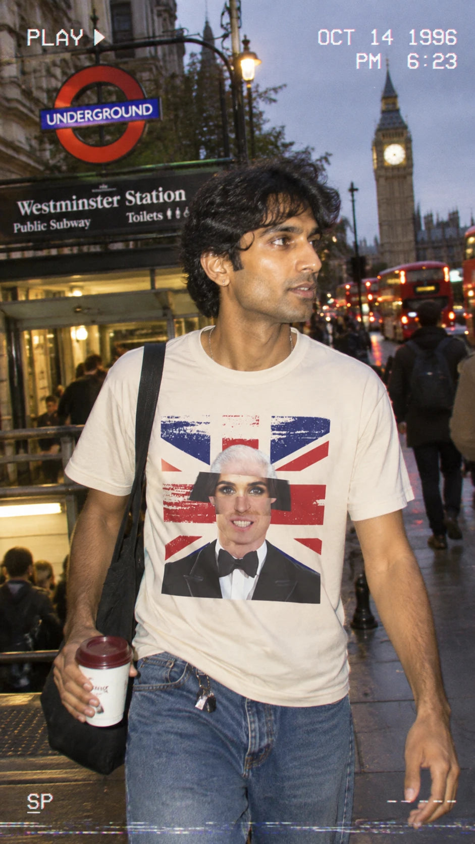 Man wearing the natural Tantrum Media Royal Frankenstein T-Shirt near Westminster Underground station at night.