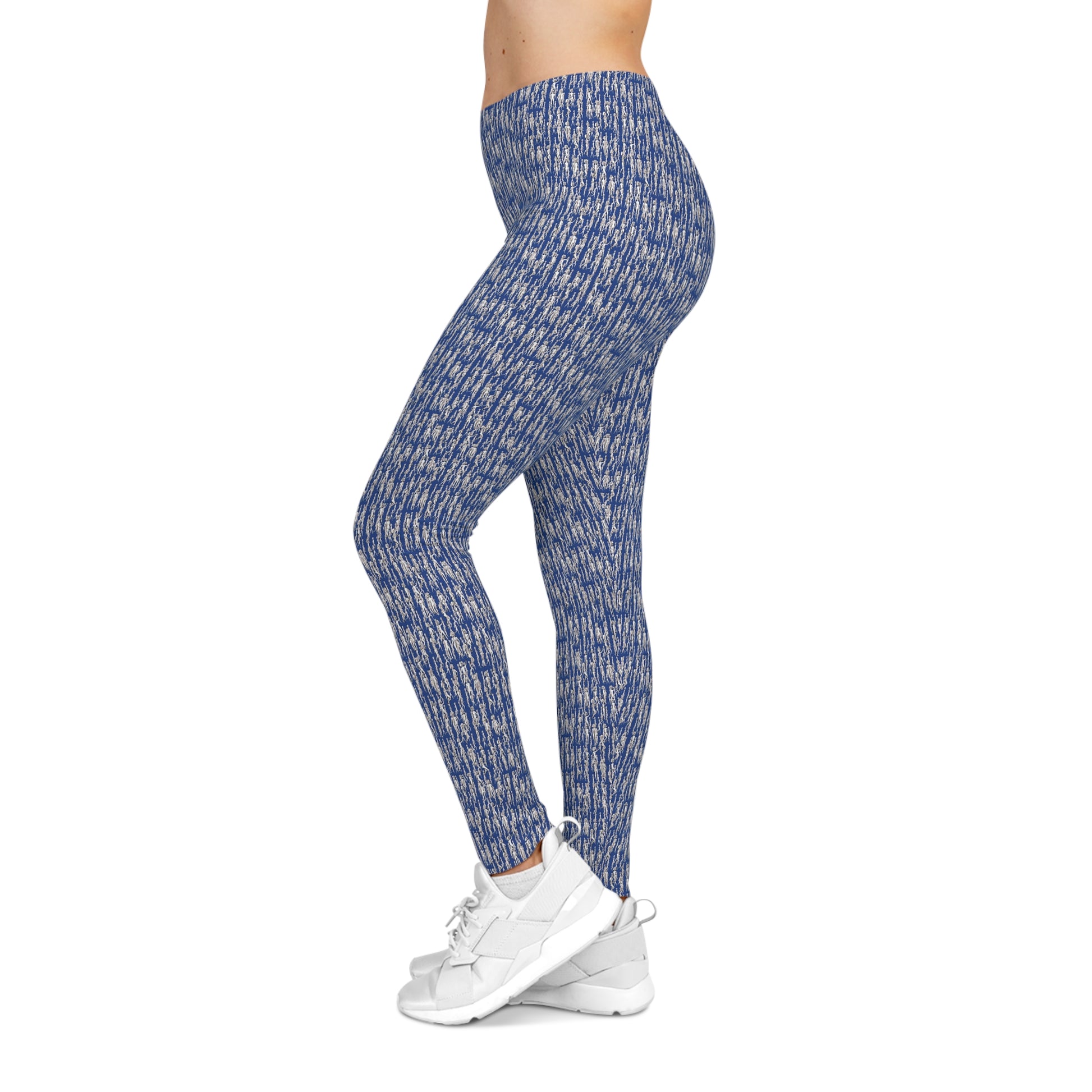 Side view of model wearing blue artistic pattern leggings with athletic styling