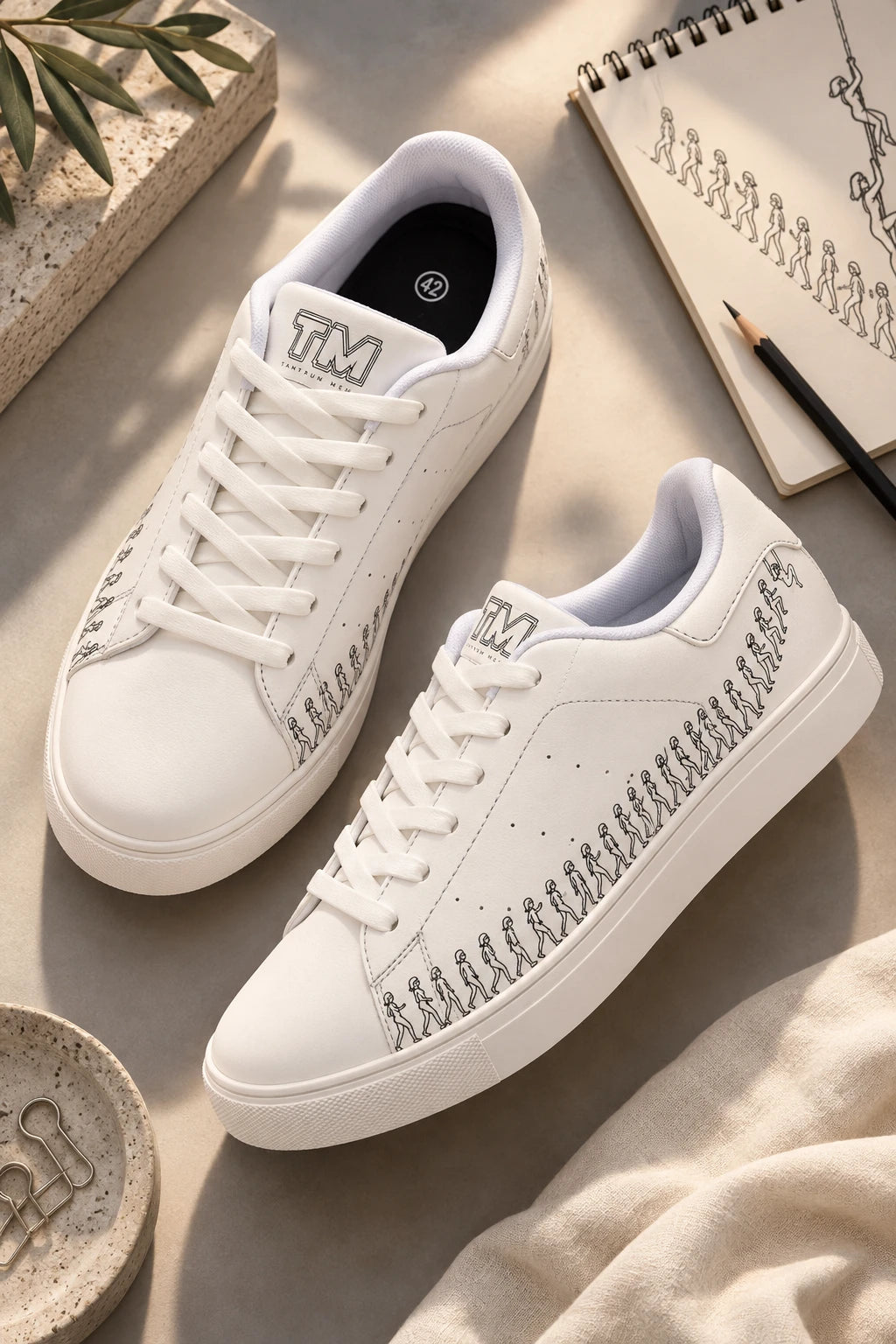 Running Out women’s white leather sneakers with white sole in artistic flat lay