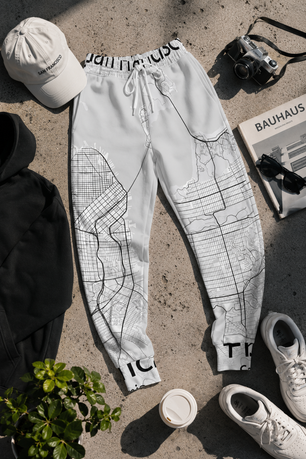 Flat lay of San Francisco map joggers with travel inspired streetwear styling