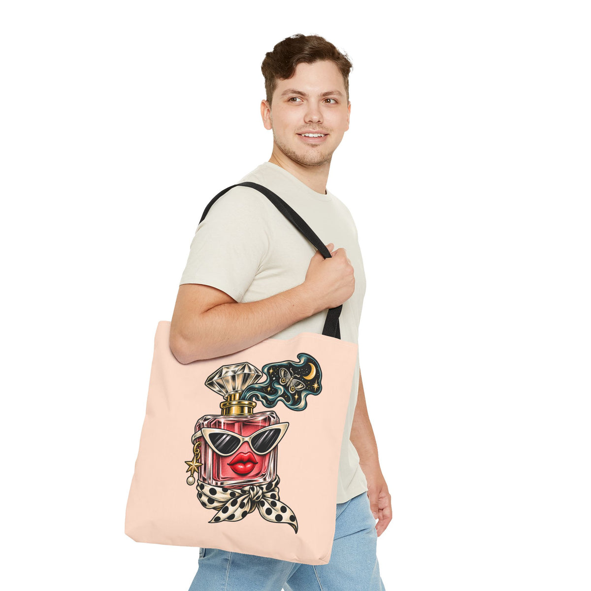 Man wearing a white T-shirt and carrying the peach Scent of Chaos graphic shoulder tote bag with black handles and colorful perfume illustration.
