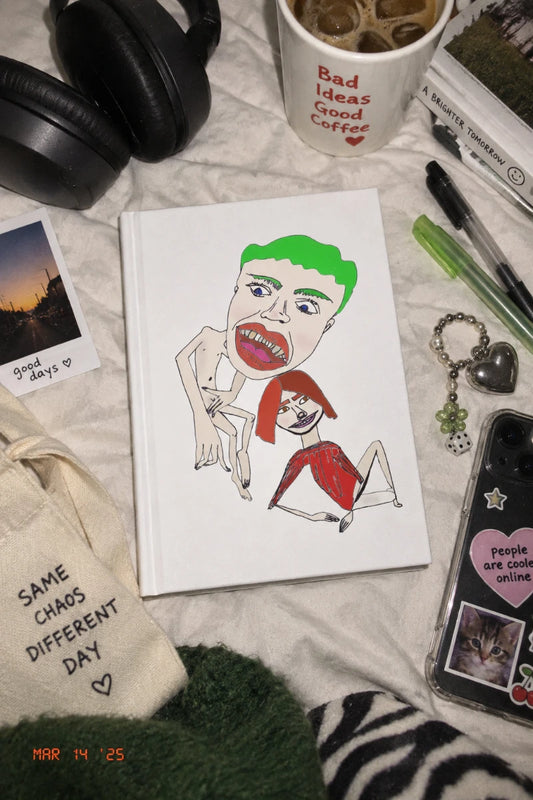 Scramble hardcover lined journal with hand-drawn artwork styled in a Gen Z bedroom flat lay