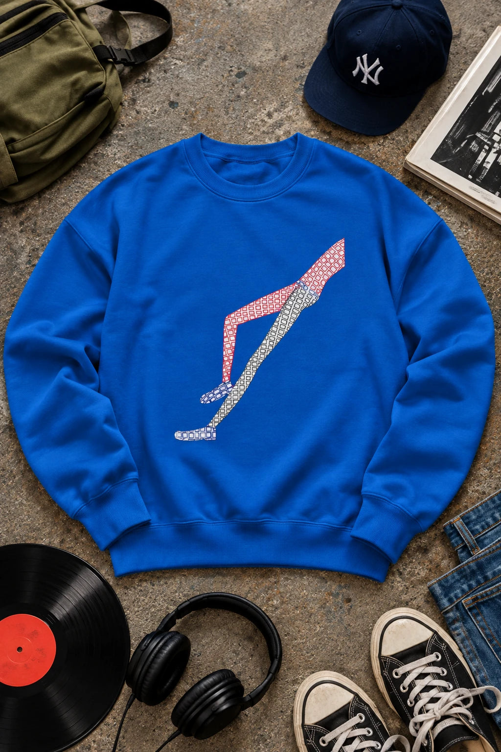 Blue Shapes in Shapes sweatshirt with original hand-drawn abstract leg graphic in editorial flat lay.