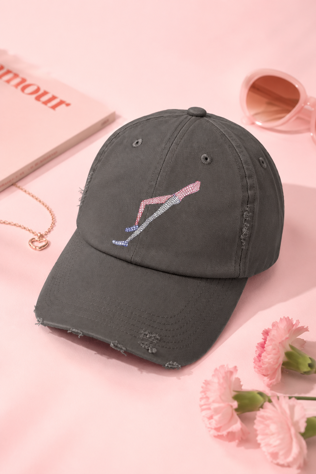 Shapes in Shapes grey distressed baseball cap flat lay on a soft pink editorial background.