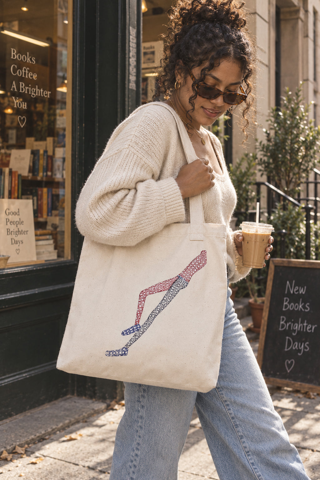 Woman carrying Shapes in Shapes natural organic cotton art tote bag in a casual city lifestyle scene
