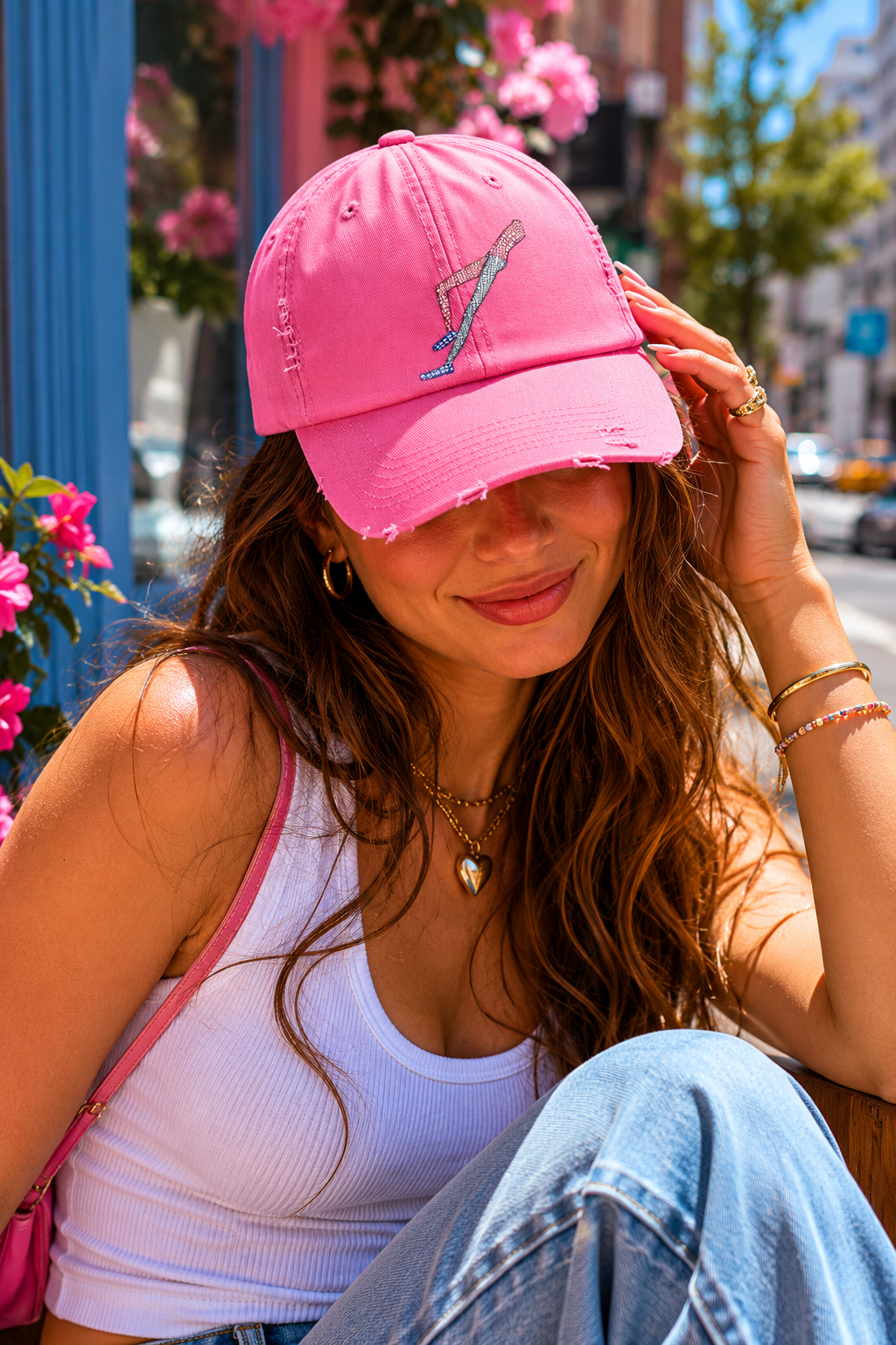 Gen Z woman wearing Shapes in Shapes pink distressed baseball cap in a colorful city lifestyle setting.