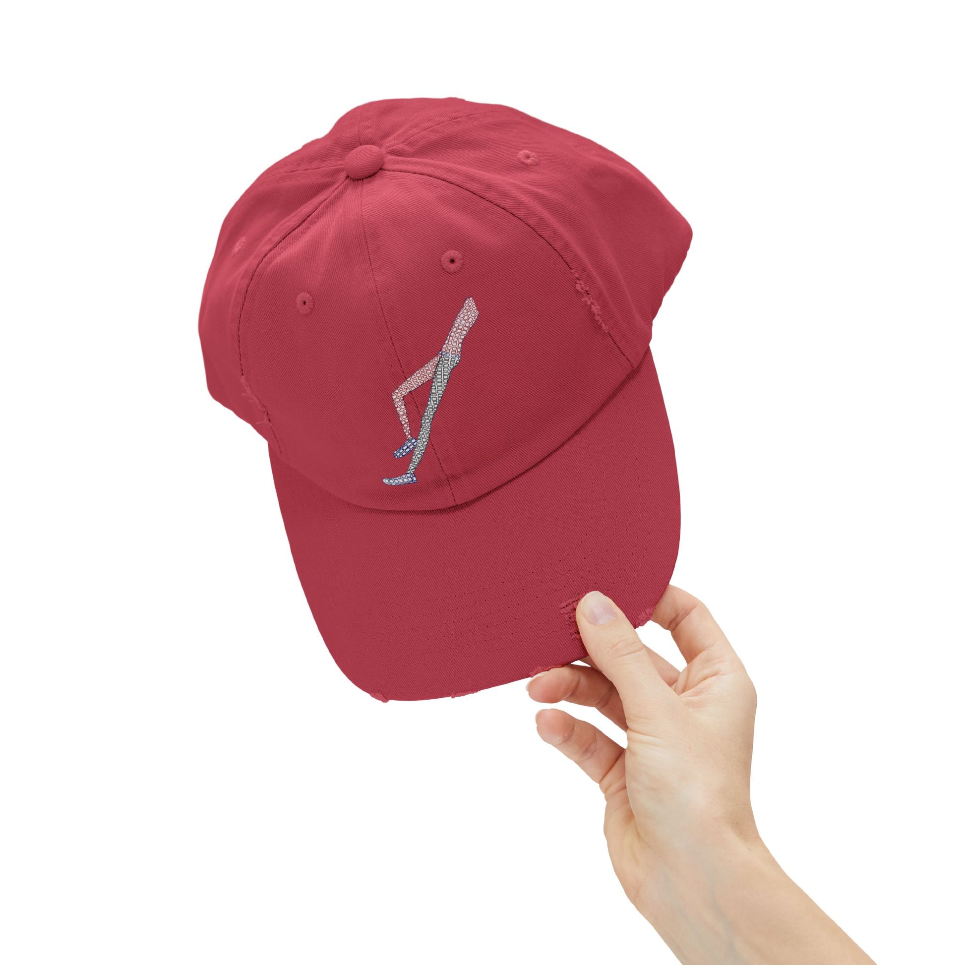 Close-up of Shapes in Shapes red distressed baseball cap showcasing embroidered artwork and distressed finish.