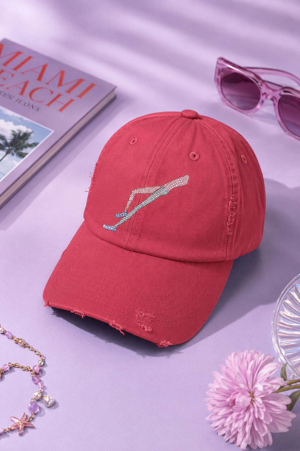 Shapes in Shapes red distressed baseball cap flat lay on a pastel purple editorial background.
