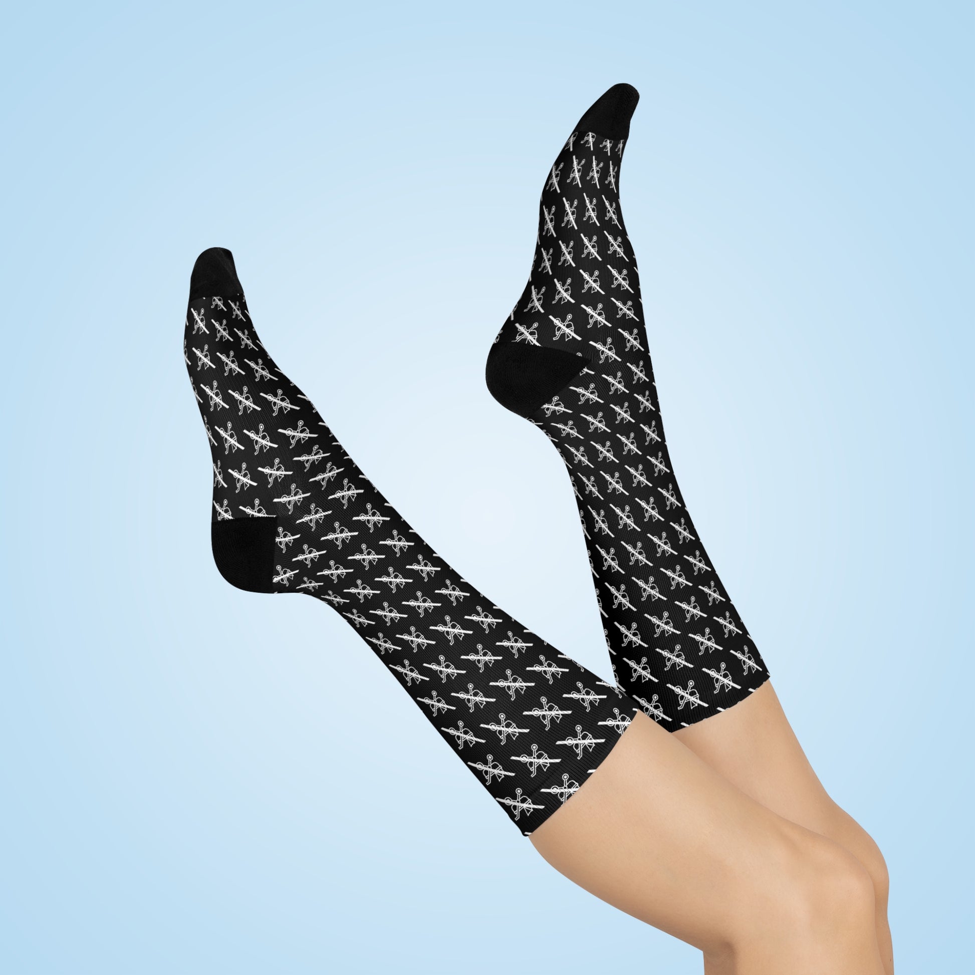 Model wearing Proudly Childless black crew socks with repeating pattern on light background