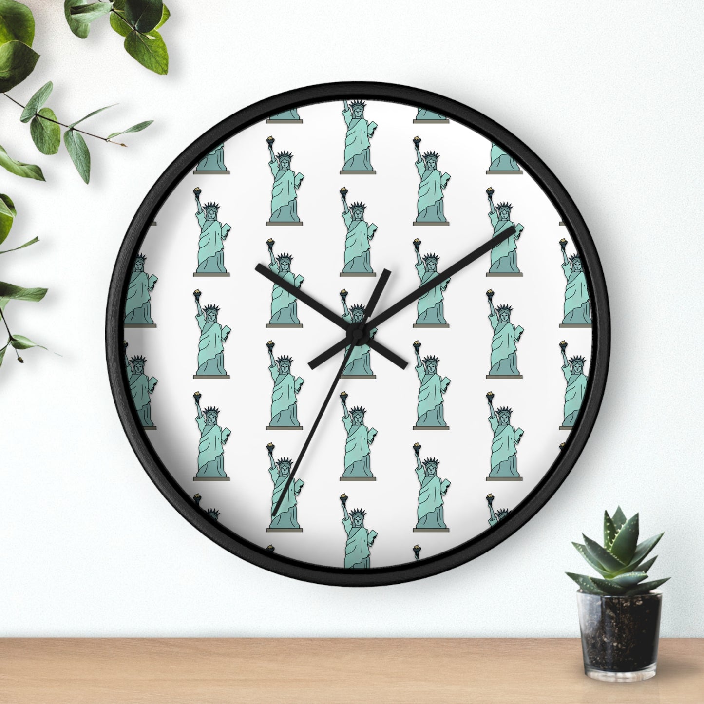 Round black wall clock featuring a repeating mint-green Statue of Liberty pattern