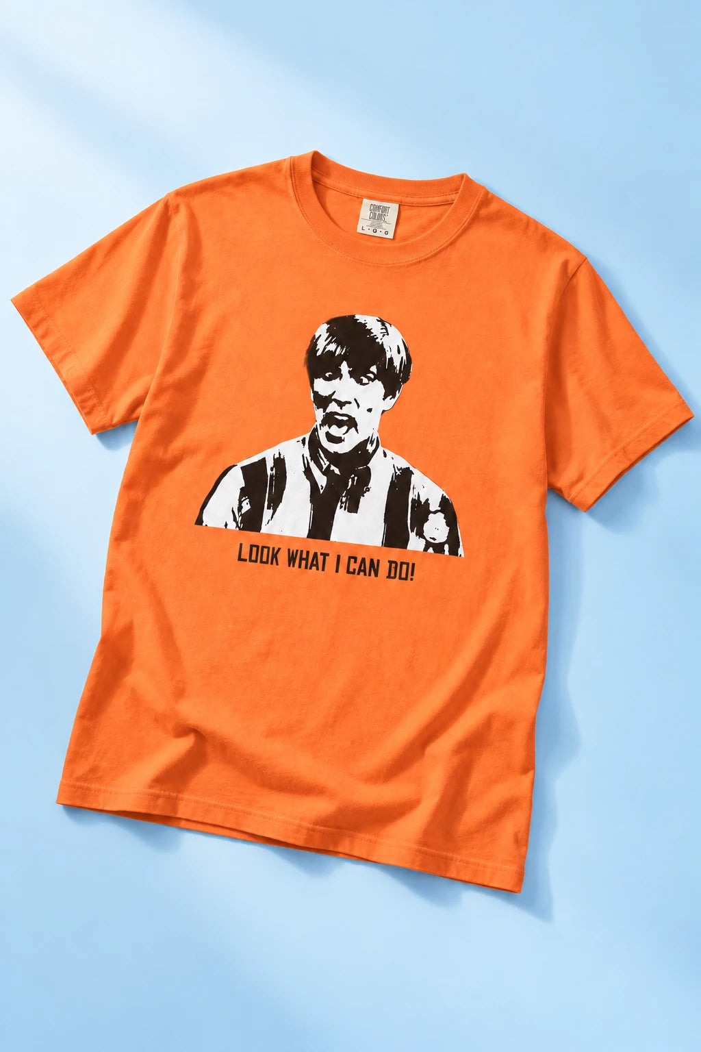 Orange Tantrum Media Stuart MadTV Unisex T-Shirt laid flat on pale blue with the portrait and catchphrase clearly visible.