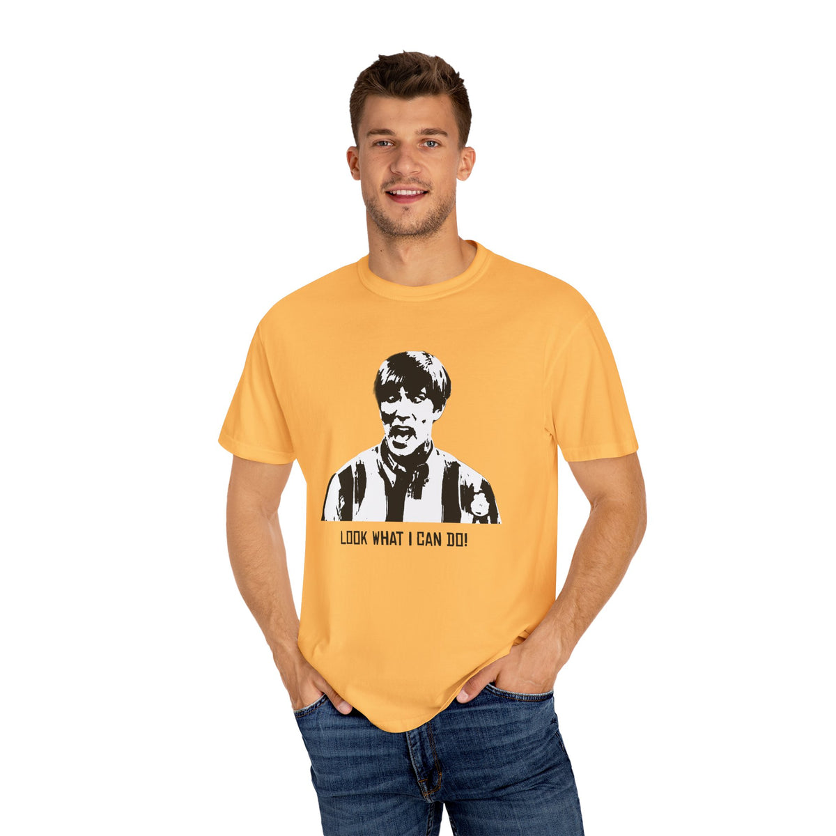 Model wearing the golden yellow Tantrum Media Stuart MadTV Unisex T-Shirt with jeans against a white studio background.