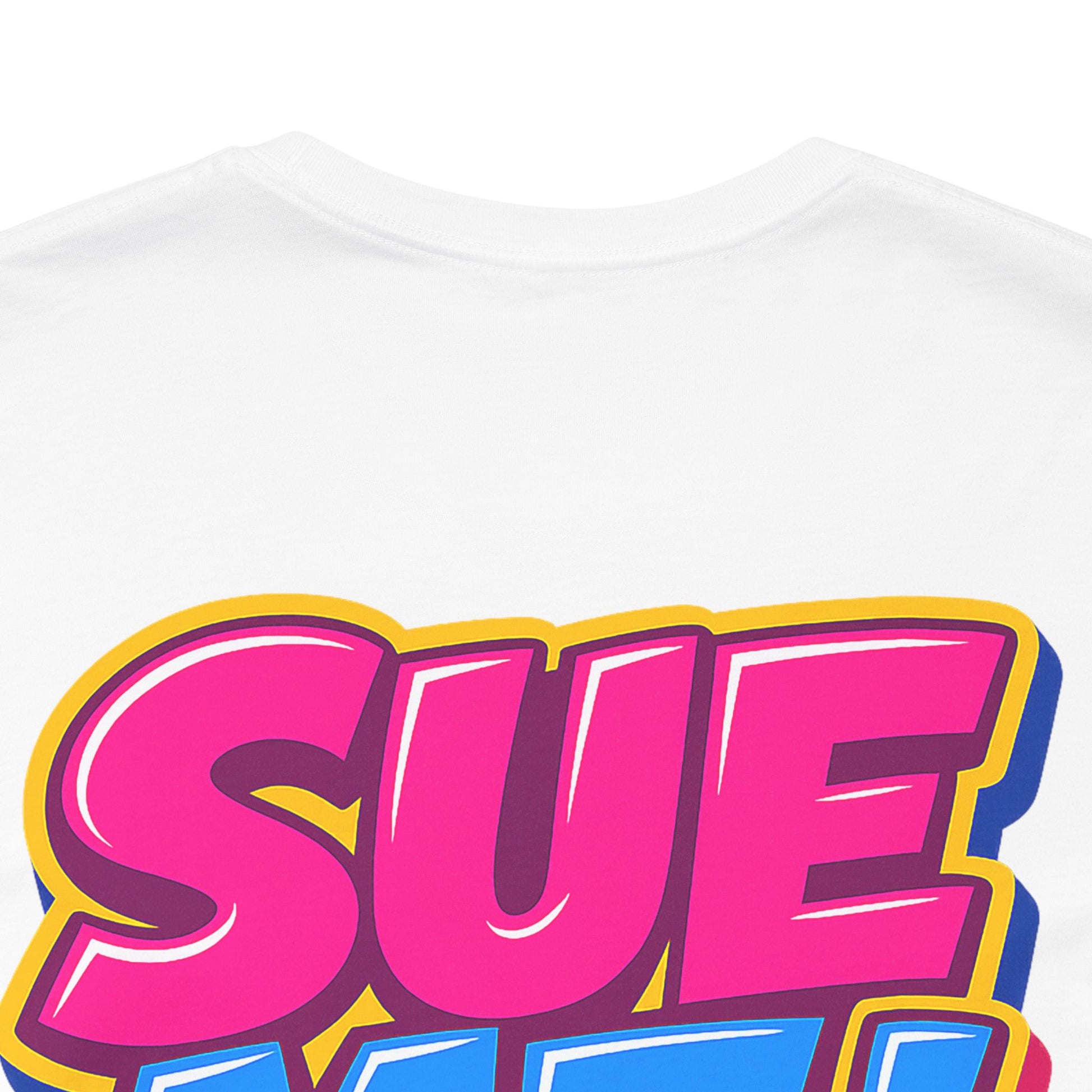 Close-up detail of colorful SUE ME comic-style graphic print on cotton T-shirt