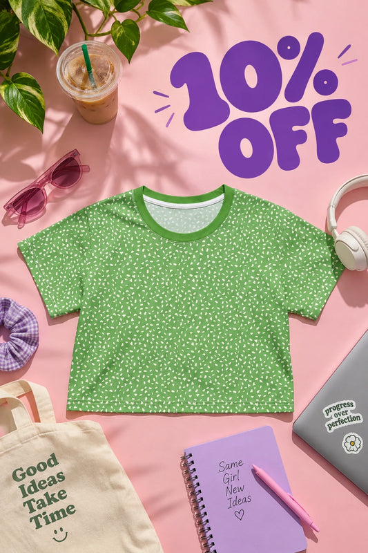 Green speckle crop top flat lay with purple 10% off lettering and colorful summer accessories