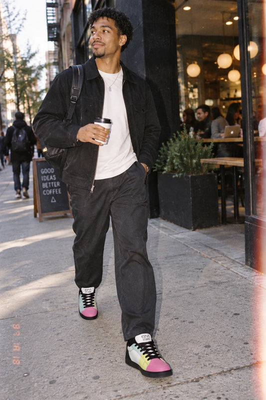 Millennial man wearing Tantrum 01 men’s low-top sneakers with black laces in an urban setting