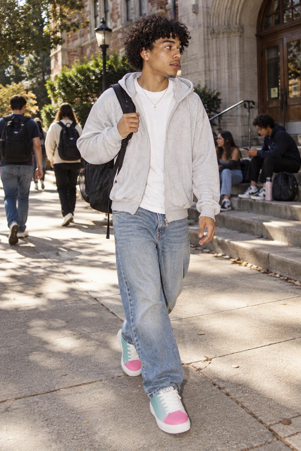 Gen Z man wearing Tantrum 01 men’s low-top sneakers with white laces on a college campus