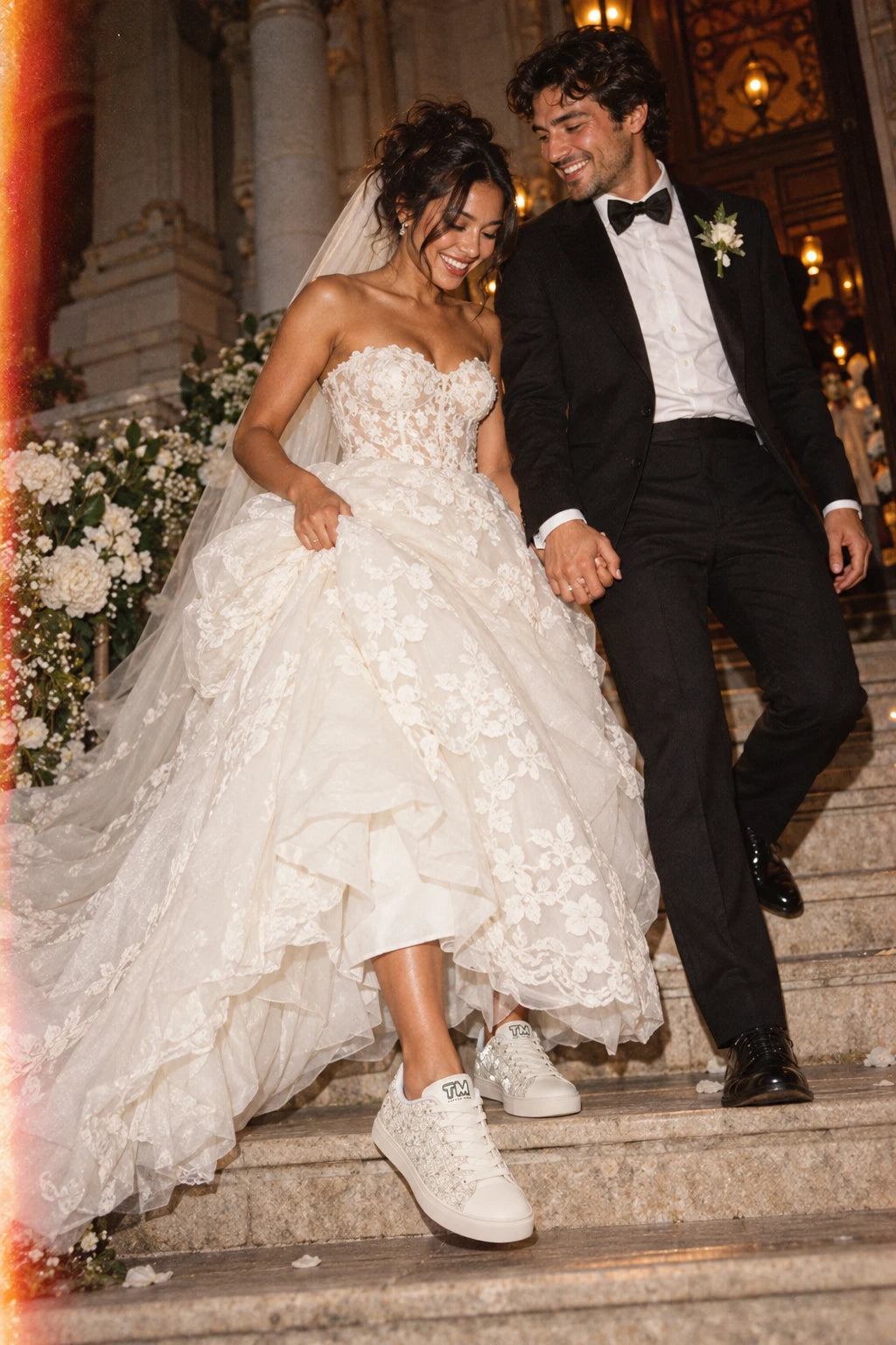 Bride wearing Tantrum 04 women’s bridal lace wedding sneakers while walking down wedding stairs with groom