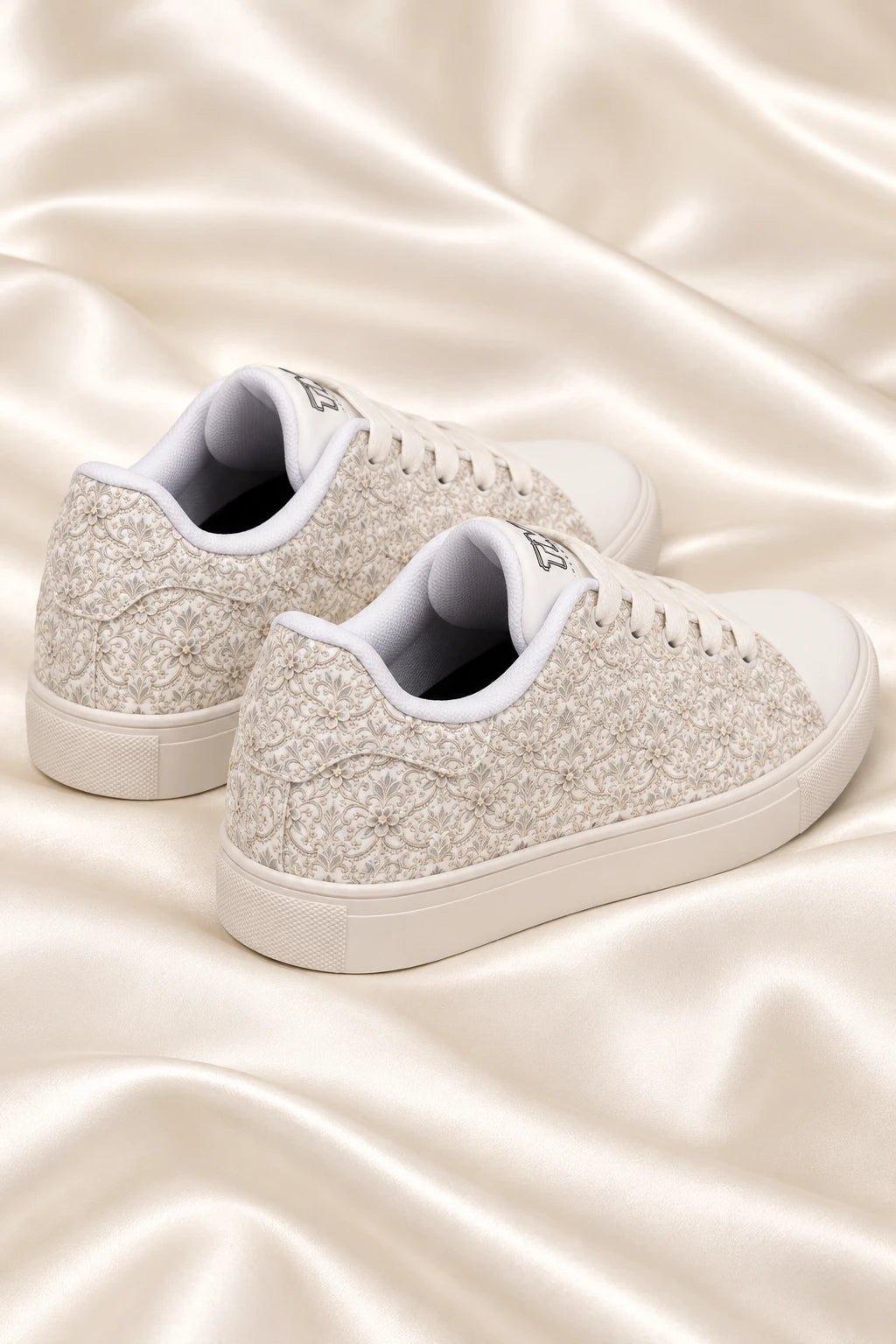 Rear angle flat lay of Tantrum 04 women’s bridal lace wedding sneakers on ivory satin
