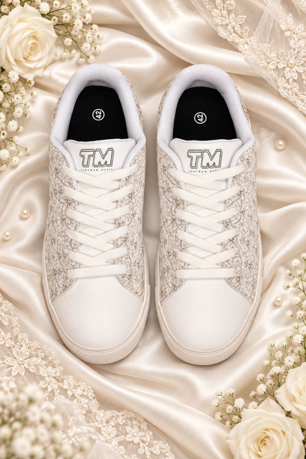 Top flat lay of Tantrum 04 women’s bridal lace wedding sneakers on ivory satin