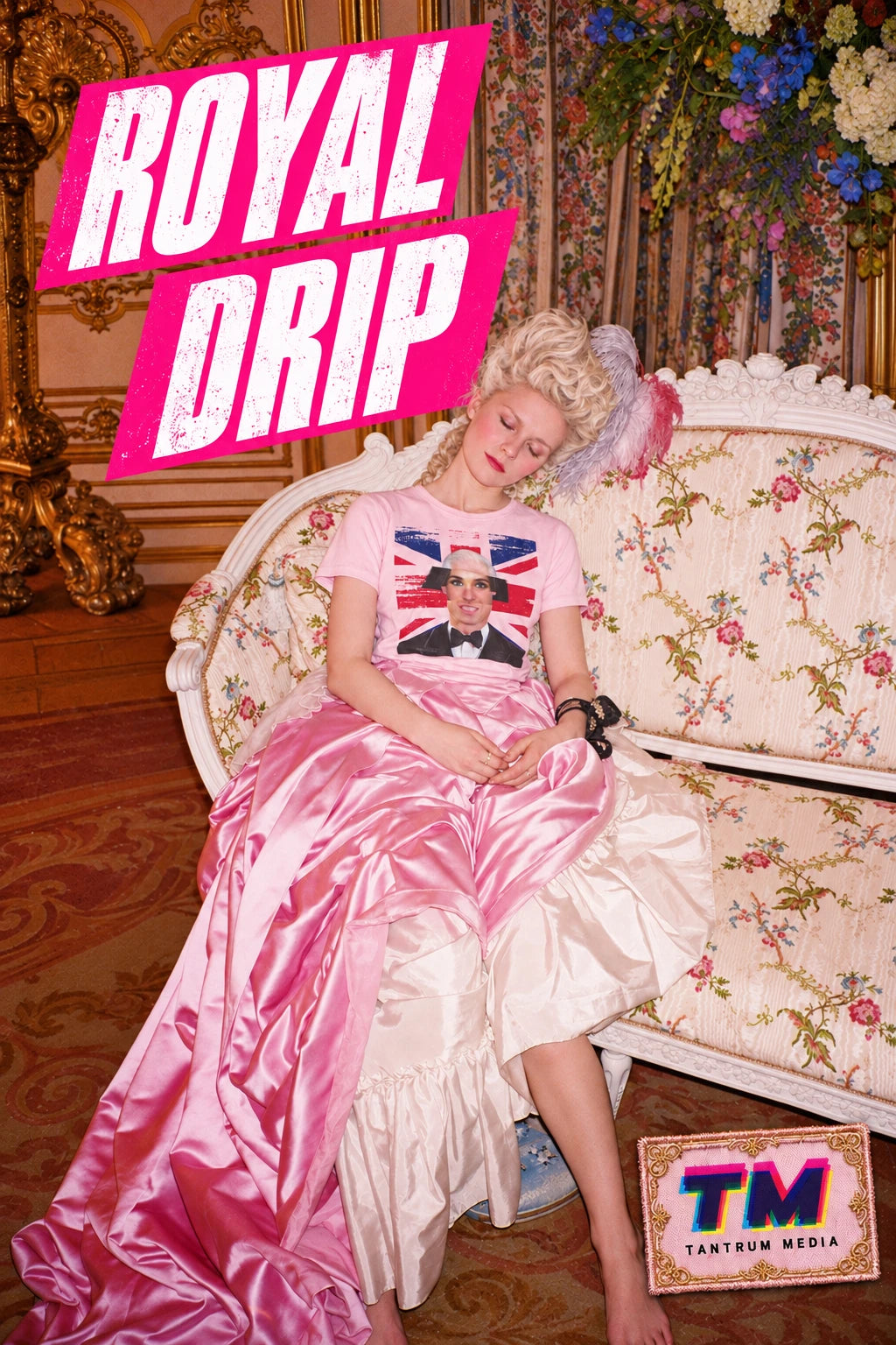 Woman wearing a pink Tantrum Media Royal Frankenstein T-Shirt with a royal portrait collage and Union Jack, seated on an ornate floral sofa beneath “Royal Drip” text.