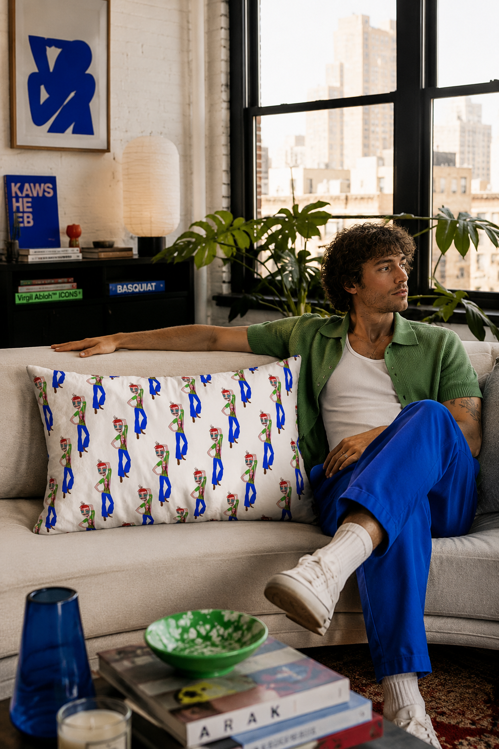 TeeMan lumbar throw pillow styled on a sofa with a millennial man in a modern Tribeca apartment
