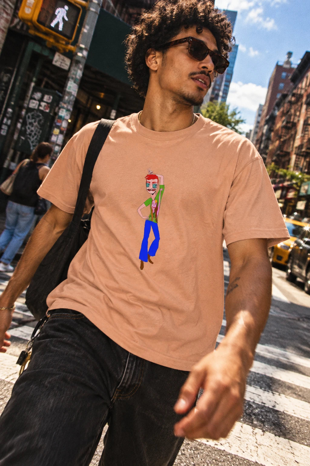 Young man wearing the TeeMan men’s graphic T-shirt in peach in an urban street setting