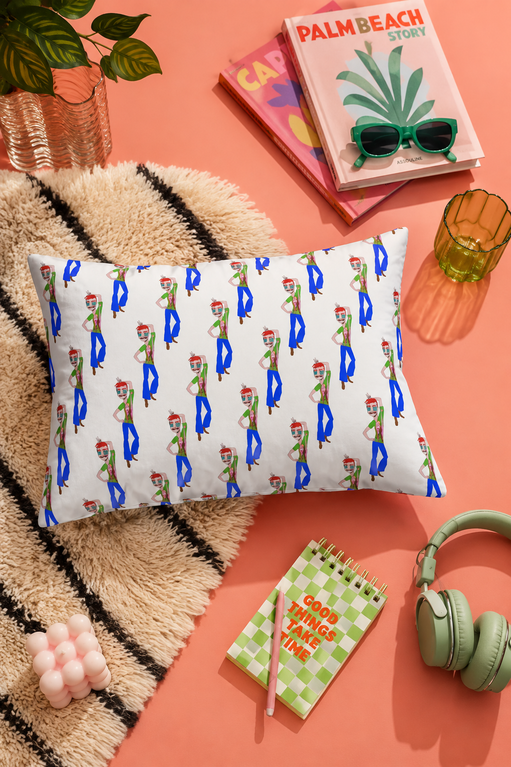 TeeMan original art lumbar pillow in a vibrant flat lay with books, headphones and modern decor