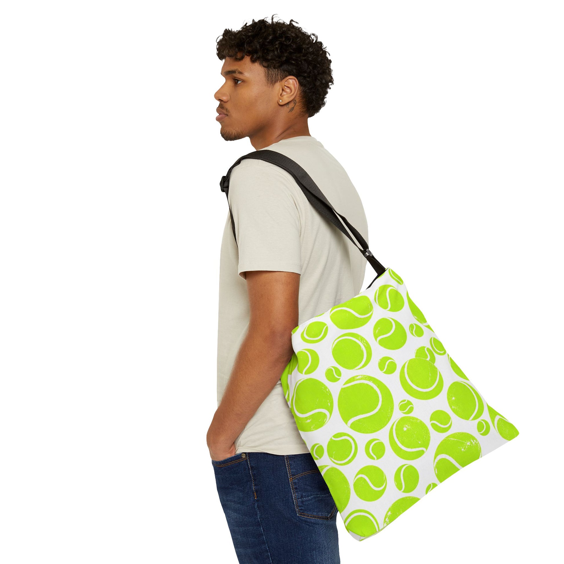 Man carrying neon green tennis ball pattern tote bag in casual everyday style
