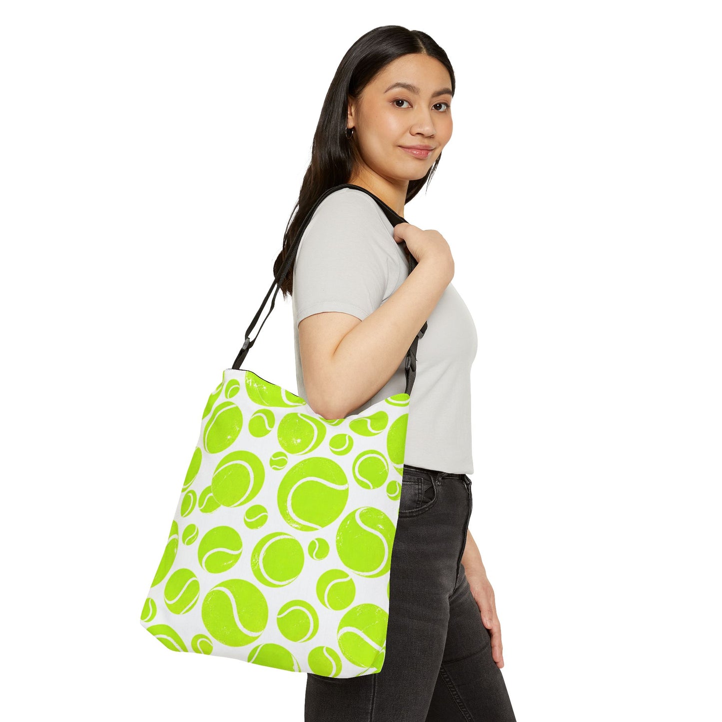 Woman modeling neon green tennis ball pattern tote bag with adjustable strap