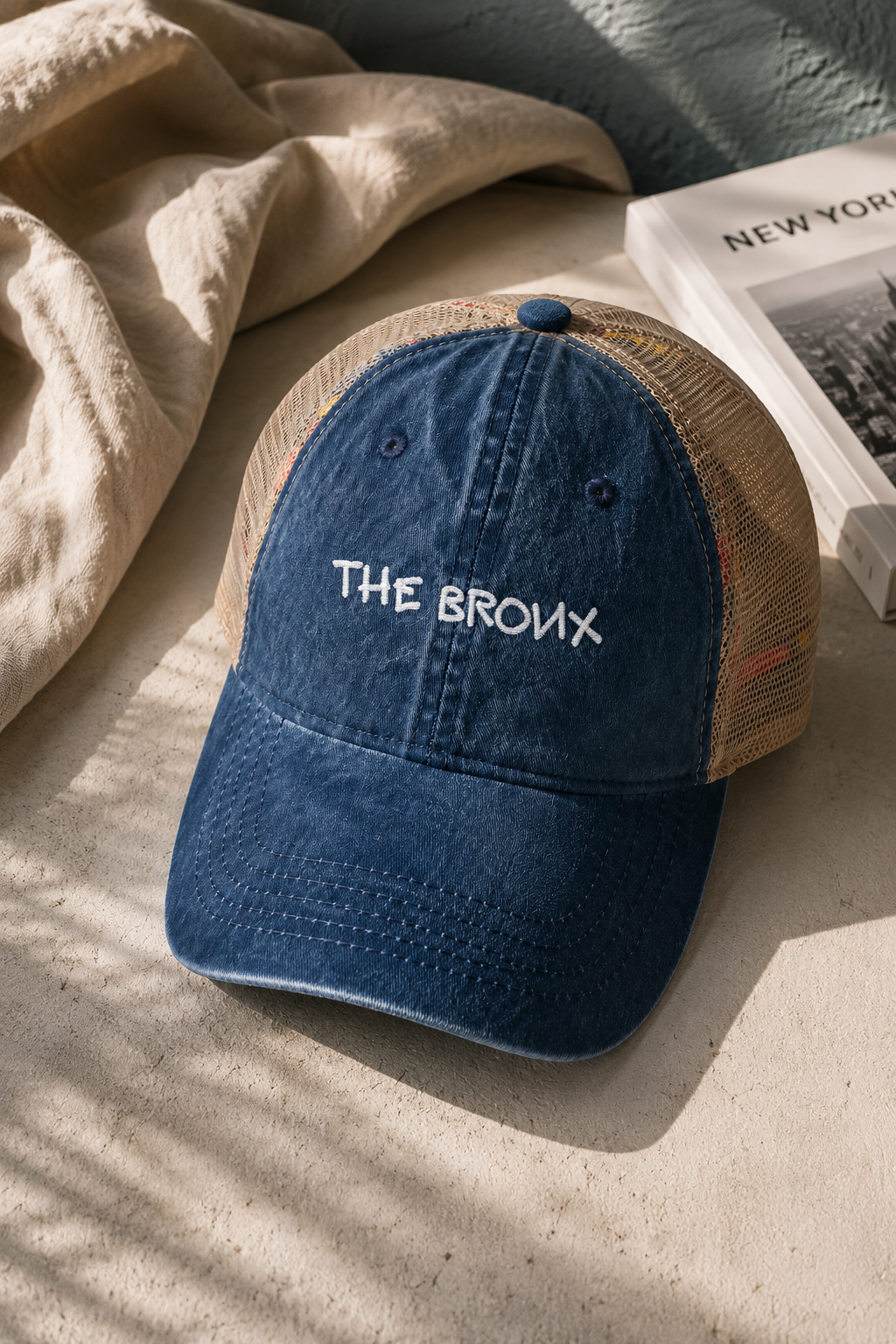 Vintage blue The Bronx trucker hat styled in a lifestyle flat lay