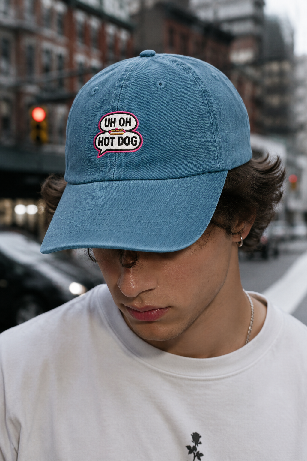 Young Gen Z male wearing light blue UH OH HOT DOG embroidered denim hat in urban streetwear lifestyle mockup