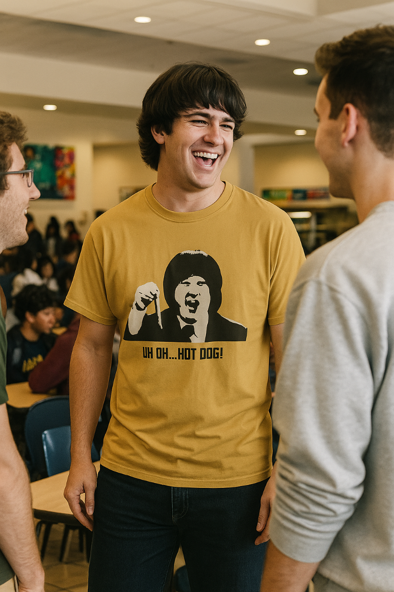 Man wearing mustard Uh Oh Hot Dog MadTV graphic T-shirt in a casual indoor setting