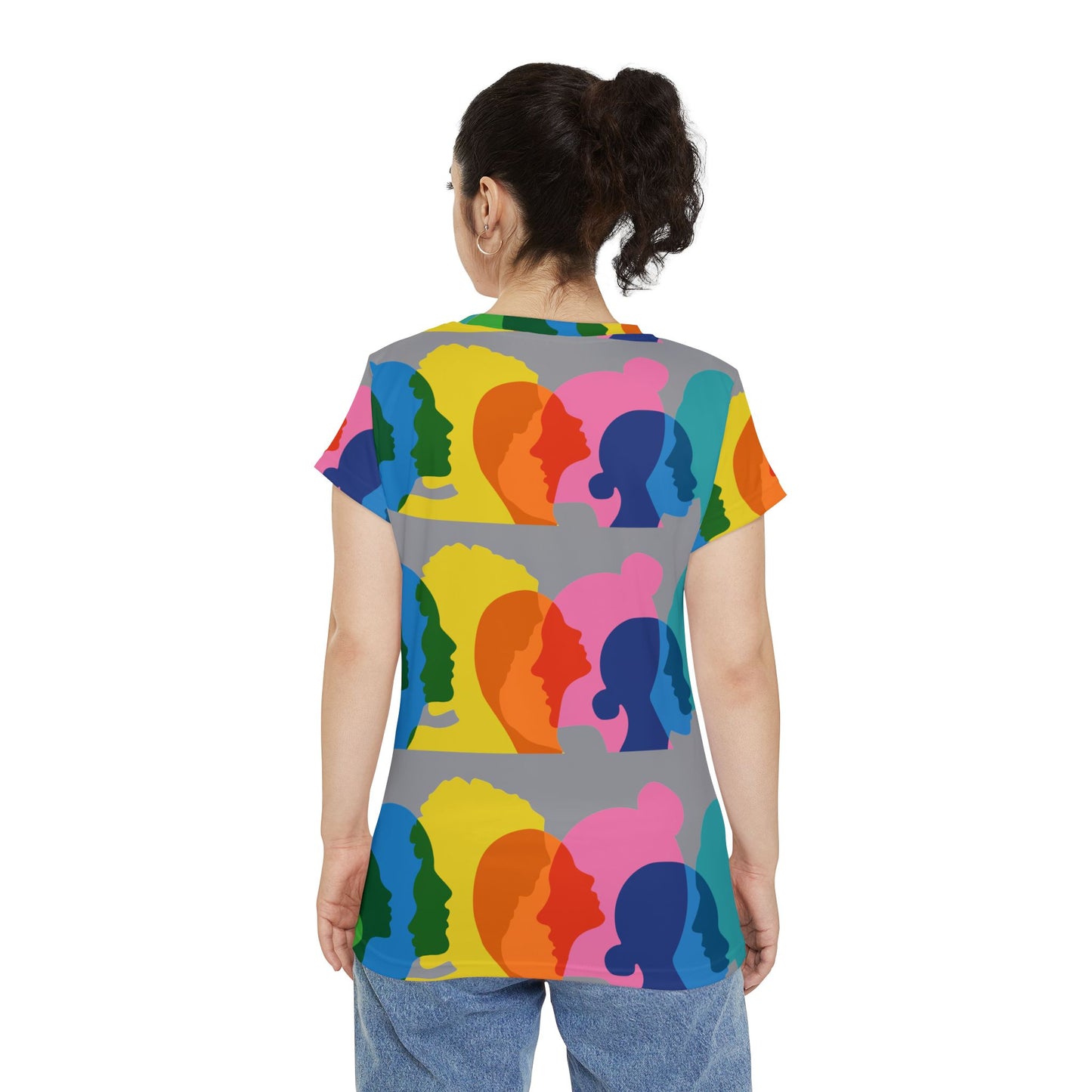 Back view of woman wearing colorful United We Stand graphic T-shirt.