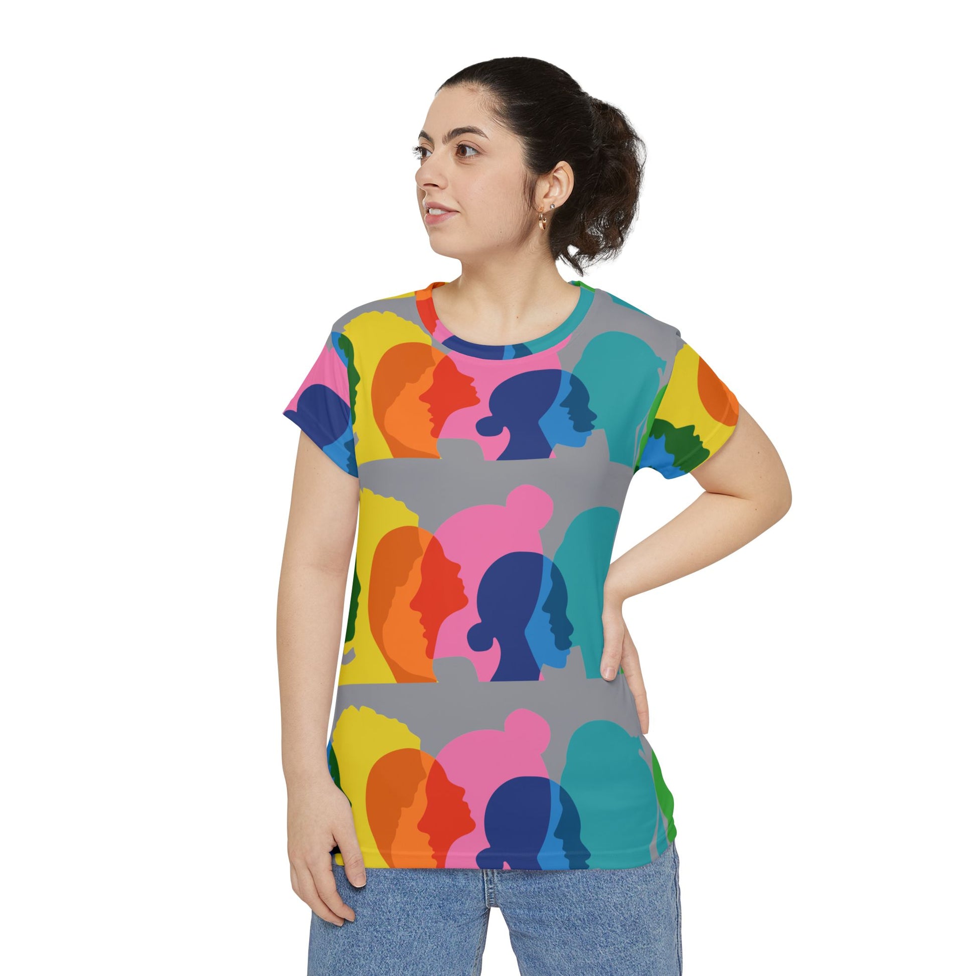 Studio lifestyle photo of woman wearing colorful equality and diversity graphic T-shirt with jeans.