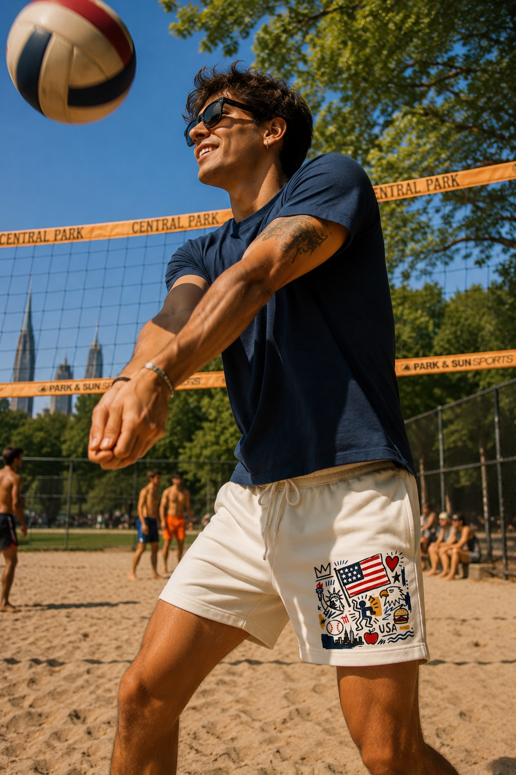Male model wearing ivory patriotic graphic sweat shorts playing volleyball