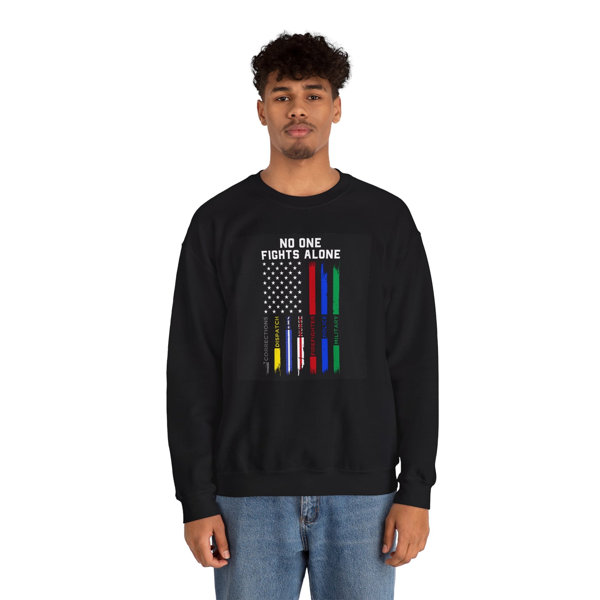 Young male model wearing black “No One Fights Alone” crewneck sweatshirt against clean studio background.