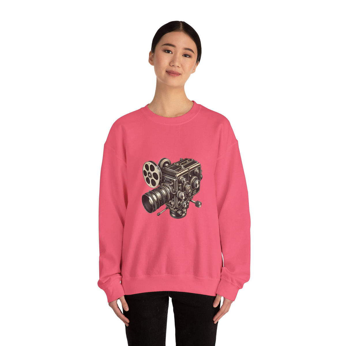 Woman wearing a Film Camera Sweatshirt in pink, standing against a plain background.