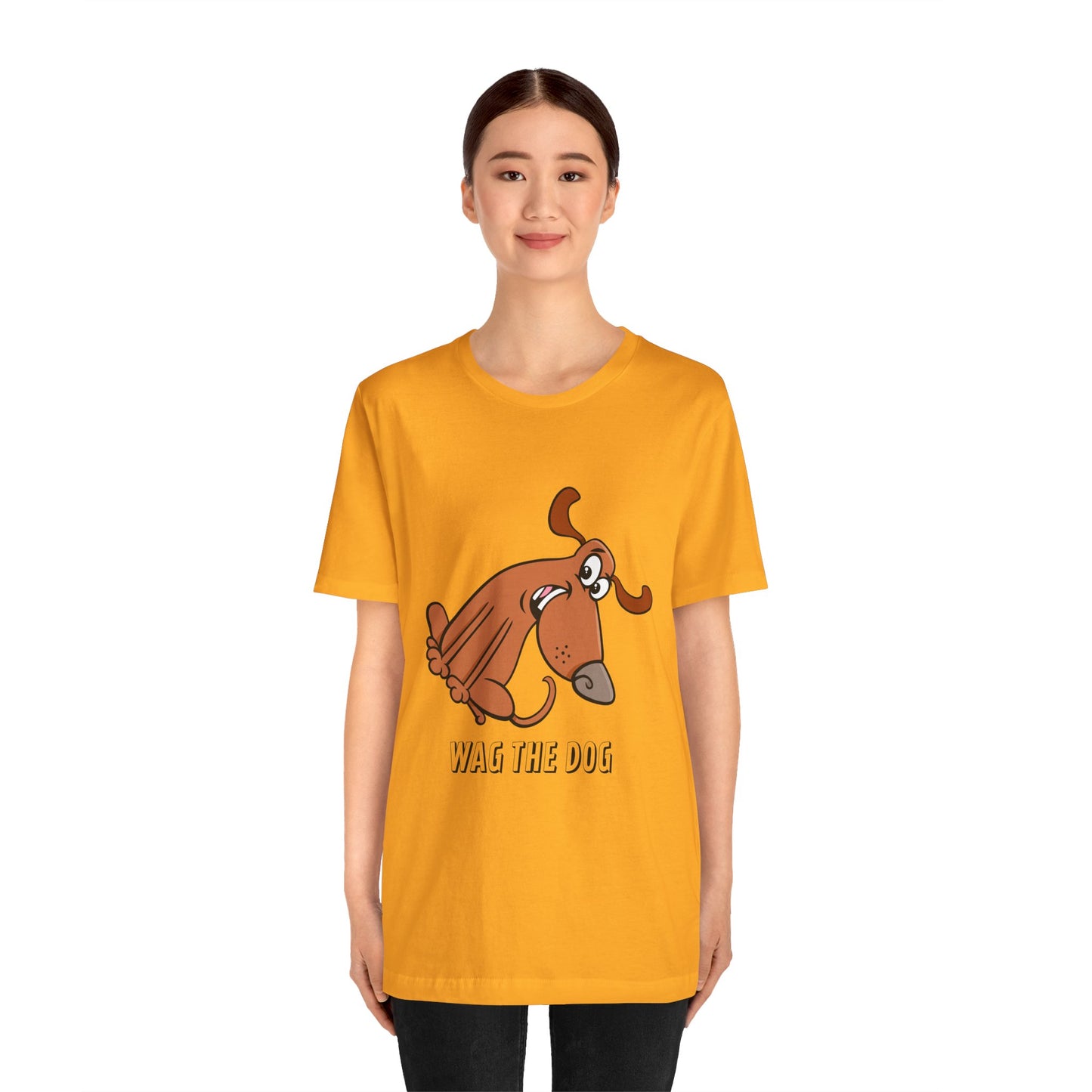 Front view of a model wearing a yellow Wag the Dog graphic t-shirt with cartoon dog illustration.