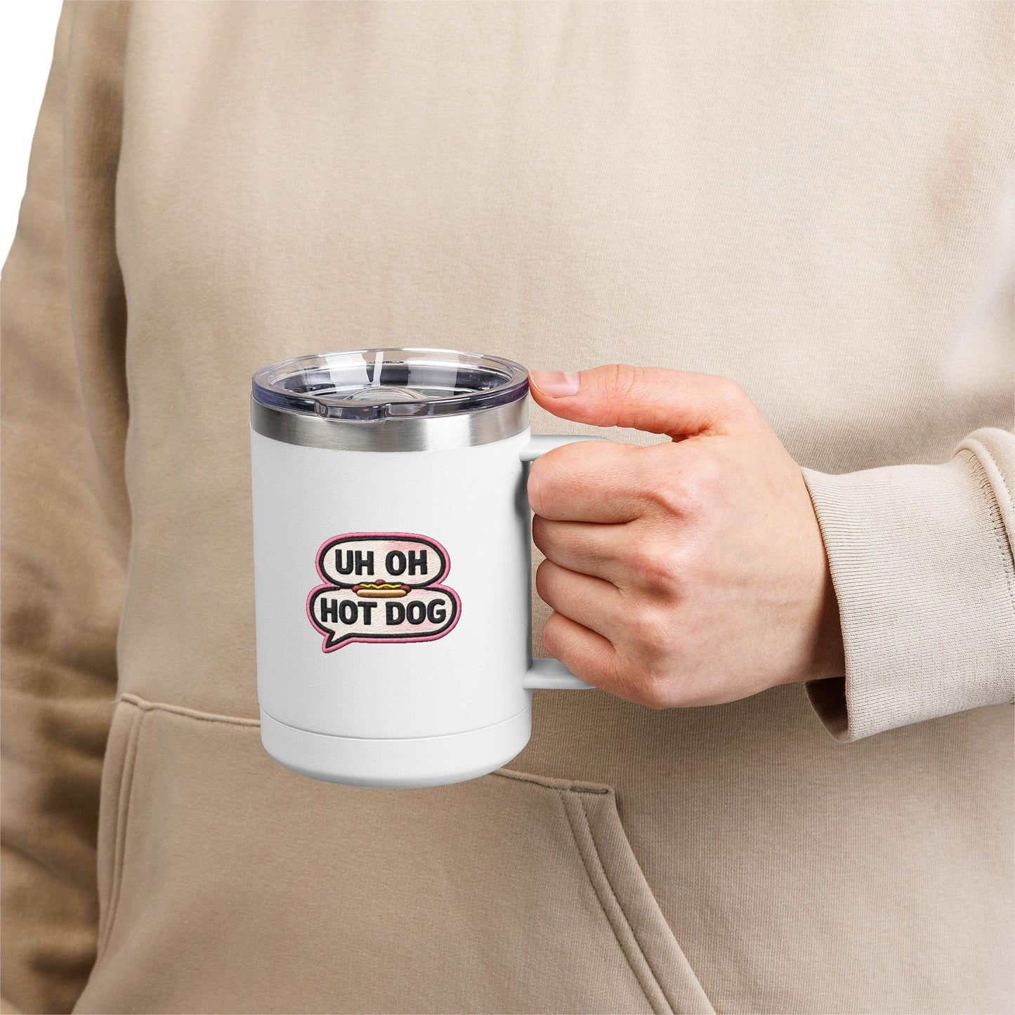 Person holding a white Uh Oh Hot Dog MADtv insulated stainless steel travel mug with clear lid and glossy comedy print