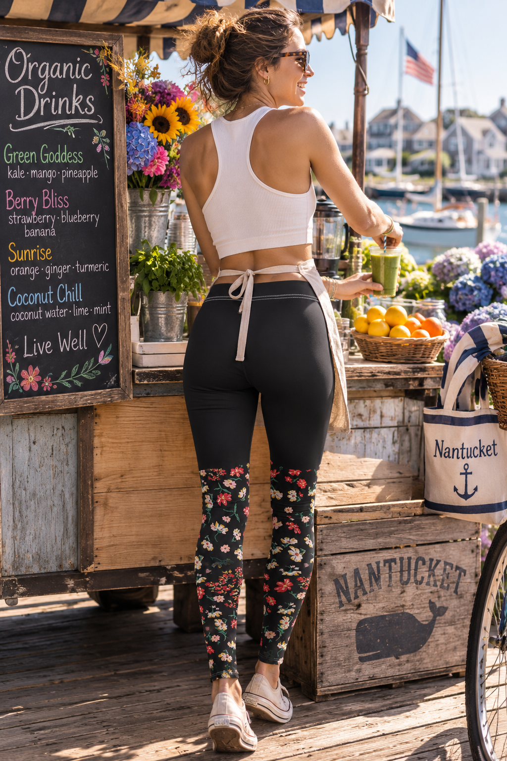 Back view of a woman wearing Wildflower Floral Yoga Leggings while working at an organic drinks stand in Nantucket.