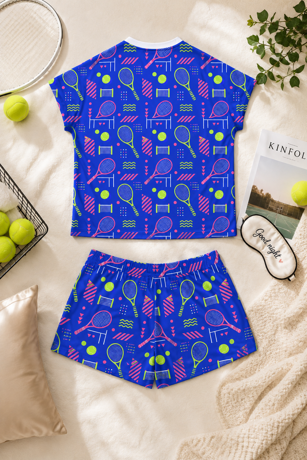 Rear view of blue women’s tennis pajama set flat lay with tennis and bedtime accessories