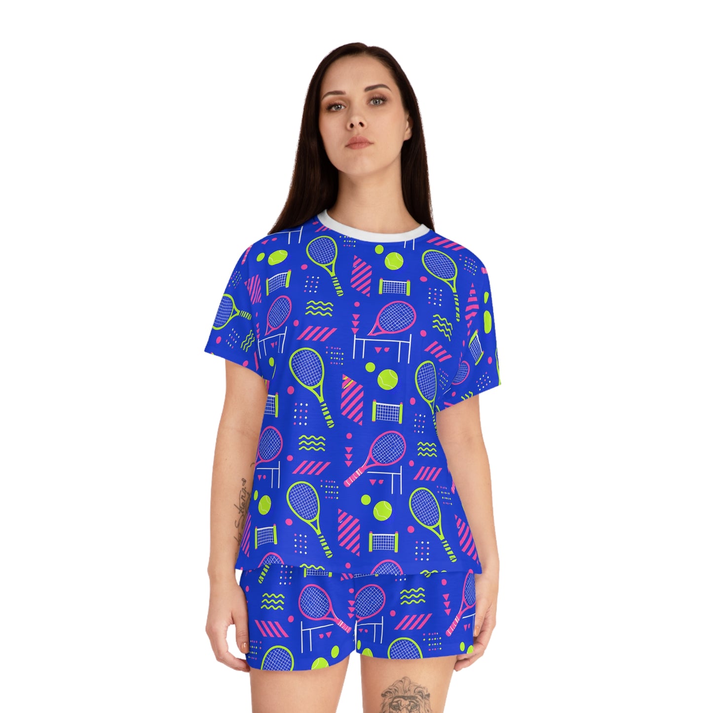 Front view of woman wearing blue tennis pajama set with colorful racket and ball pattern