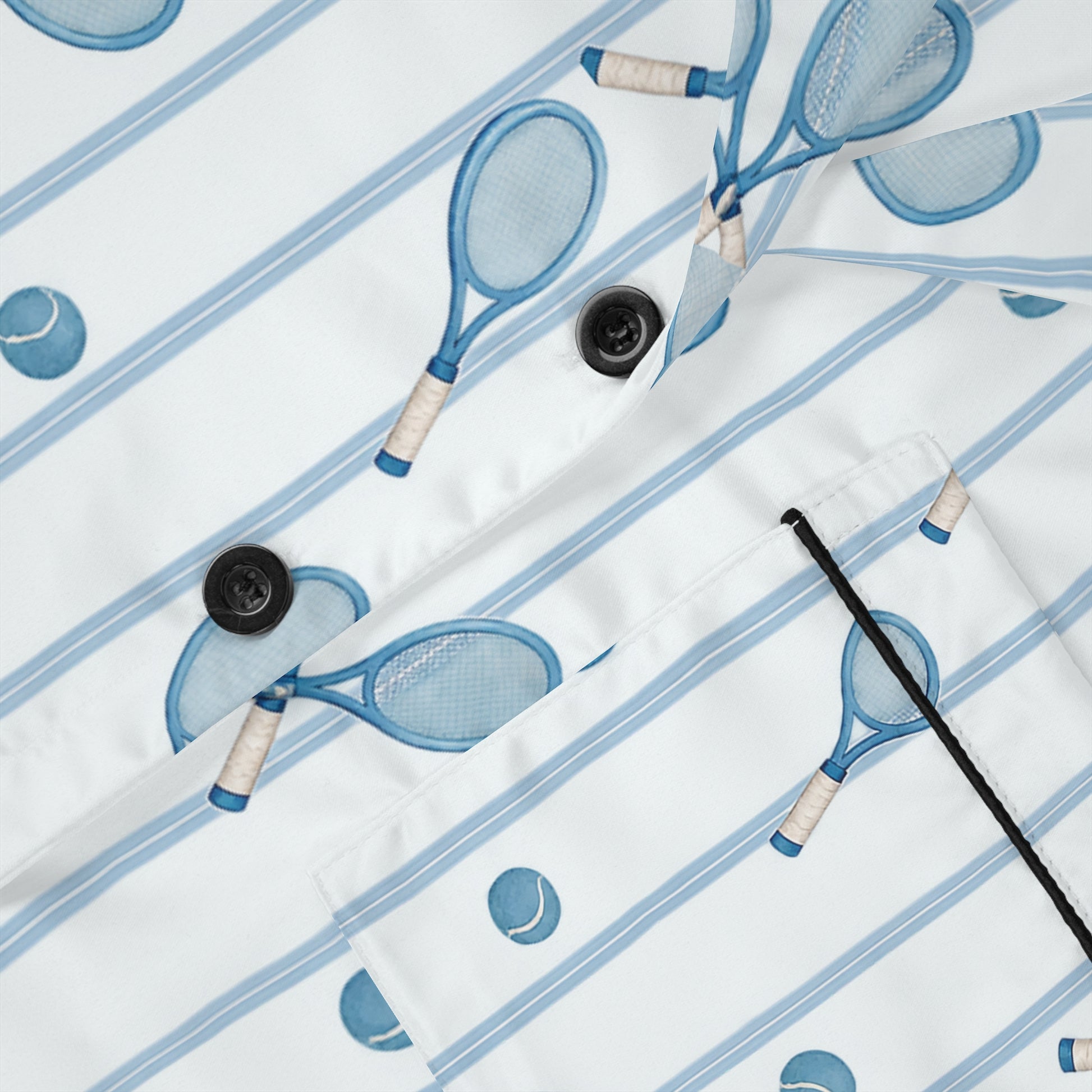 Close-up of women’s tennis satin pajamas showing blue racket print, buttons and piping