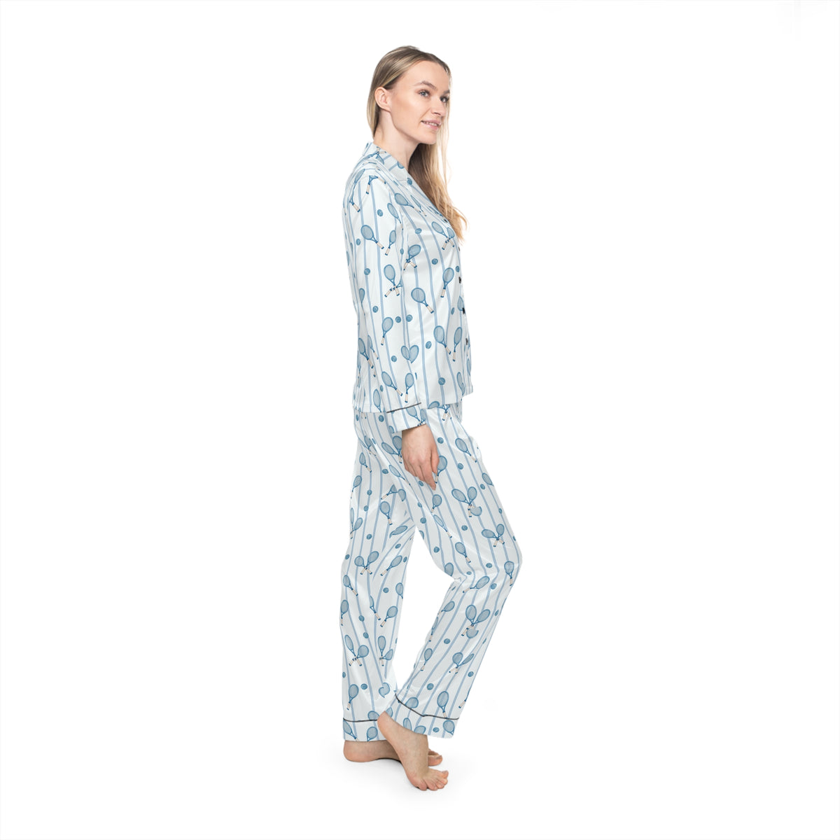 Side view of woman wearing blue tennis print satin pajamas