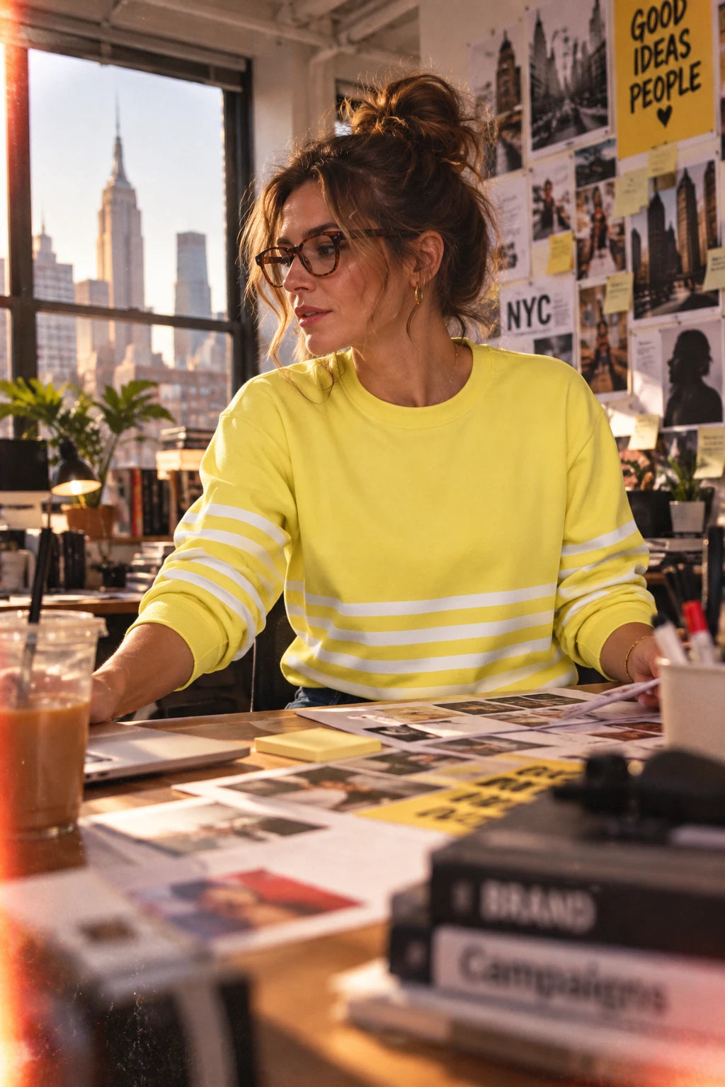 Woman wearing yellow striped sweatshirt while working in a New York City advertising agency