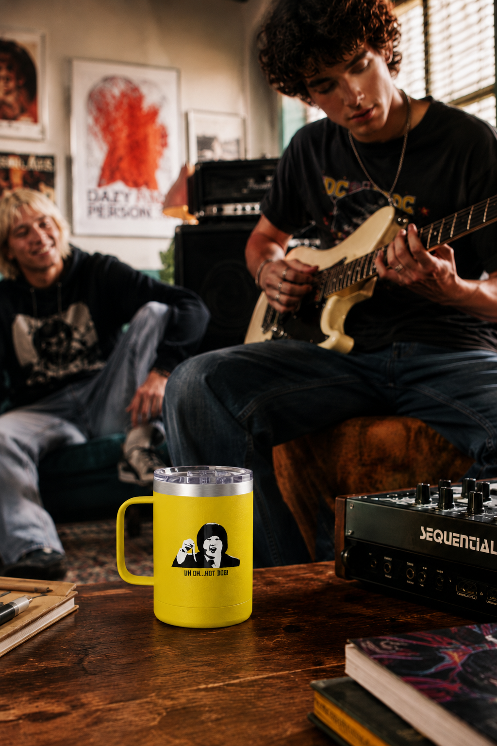 Young man holding a yellow Uh Oh Hot Dog MADtv travel mug inside a vintage record store