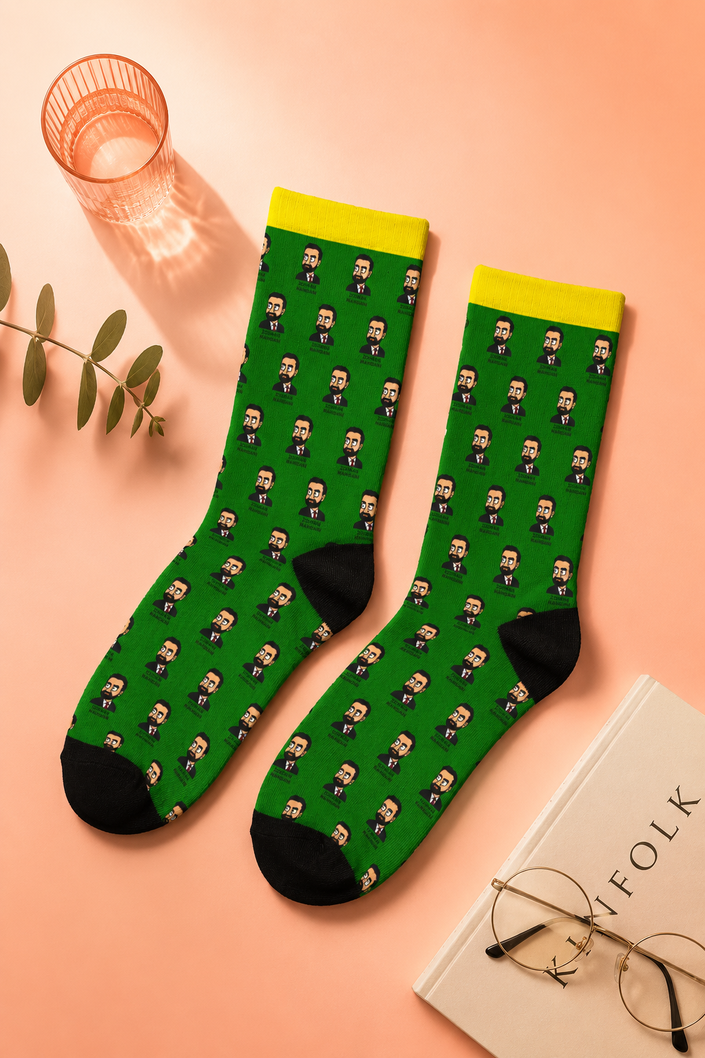 Flat-lay editorial product photography of Zohran Mamdani unisex padded crew socks on a soft peach gradient background with minimal lifestyle accessories and warm natural lighting.